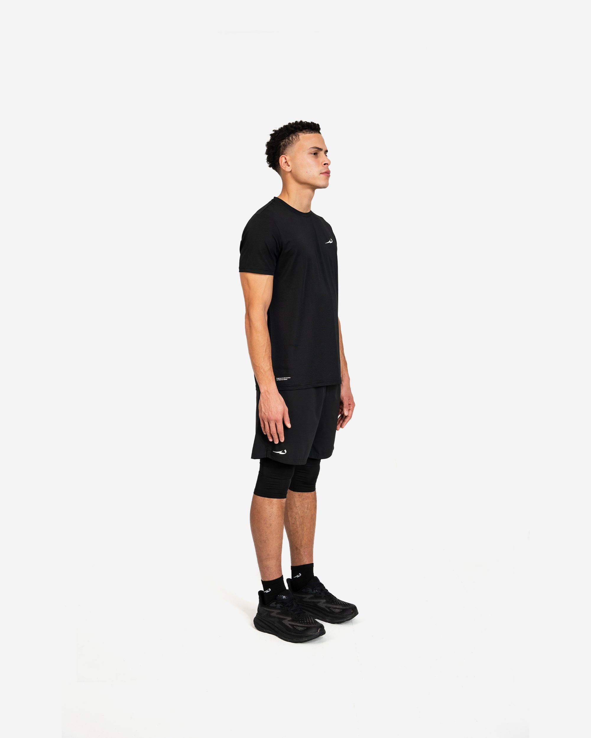 Person wearing a black deenathletic outfit on a white background