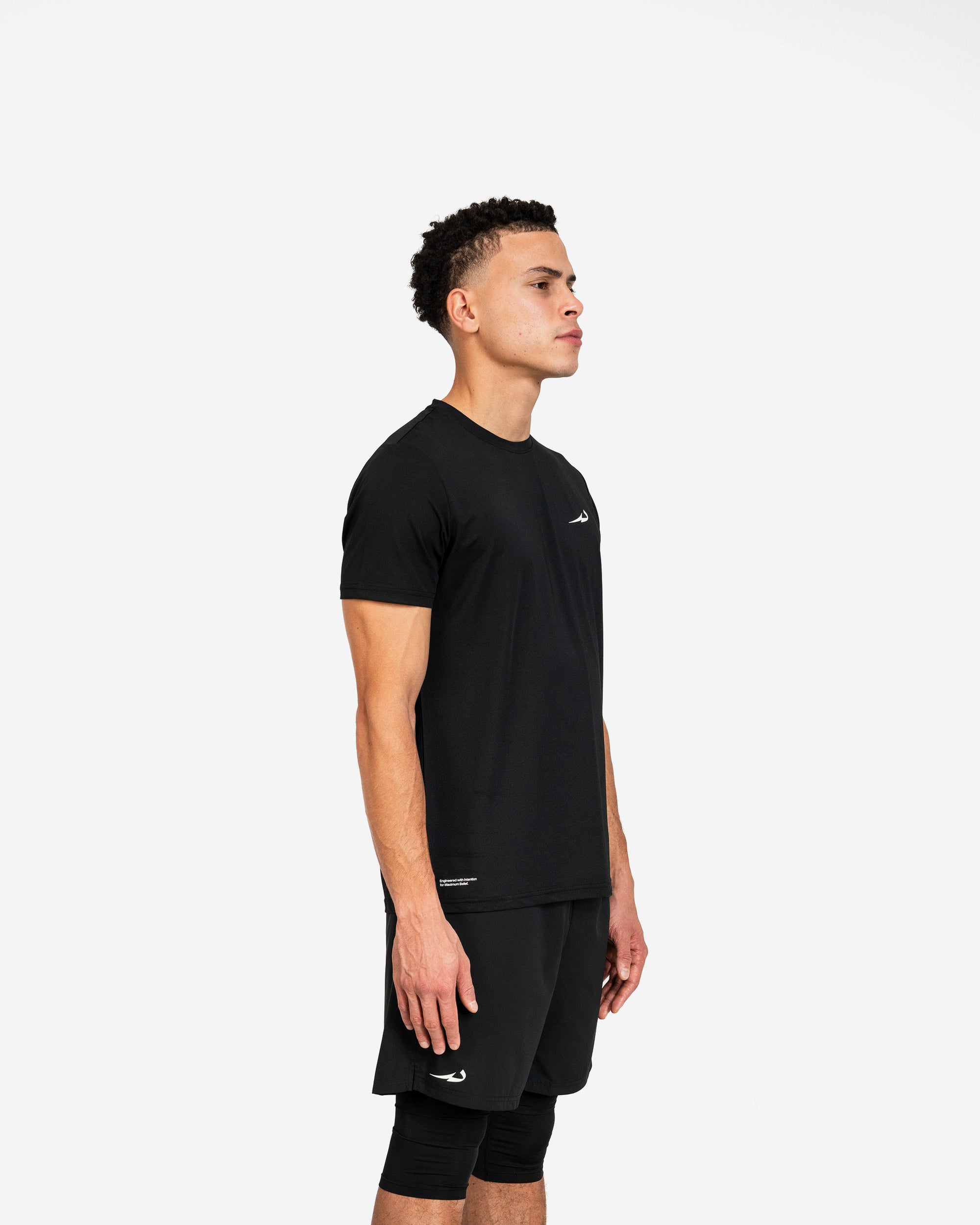 Person wearing a black athletic outfit with a deenathletic logo on a white background