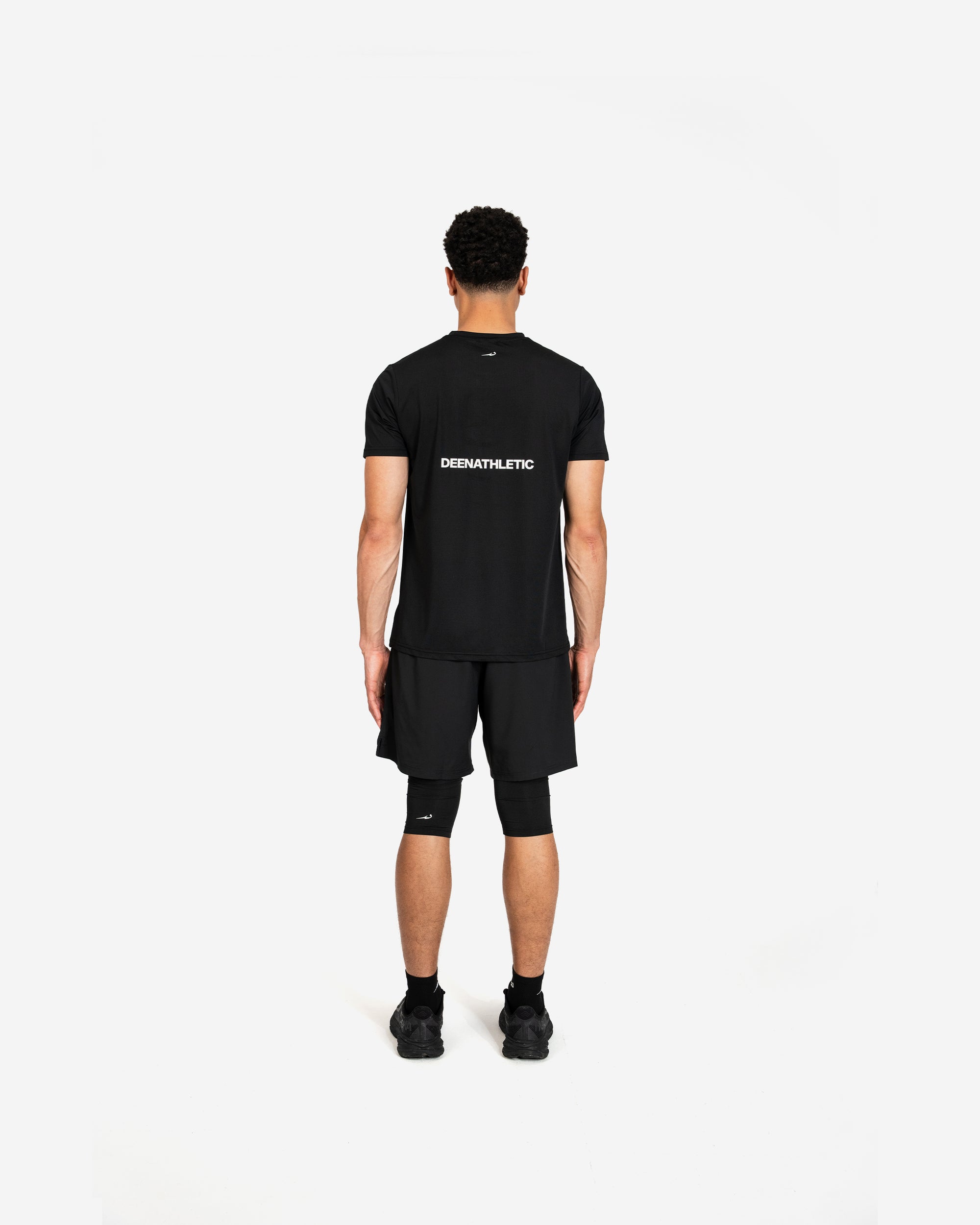 Person wearing a black t-shirt and shorts with 'Deenathletic' branding on a white background
