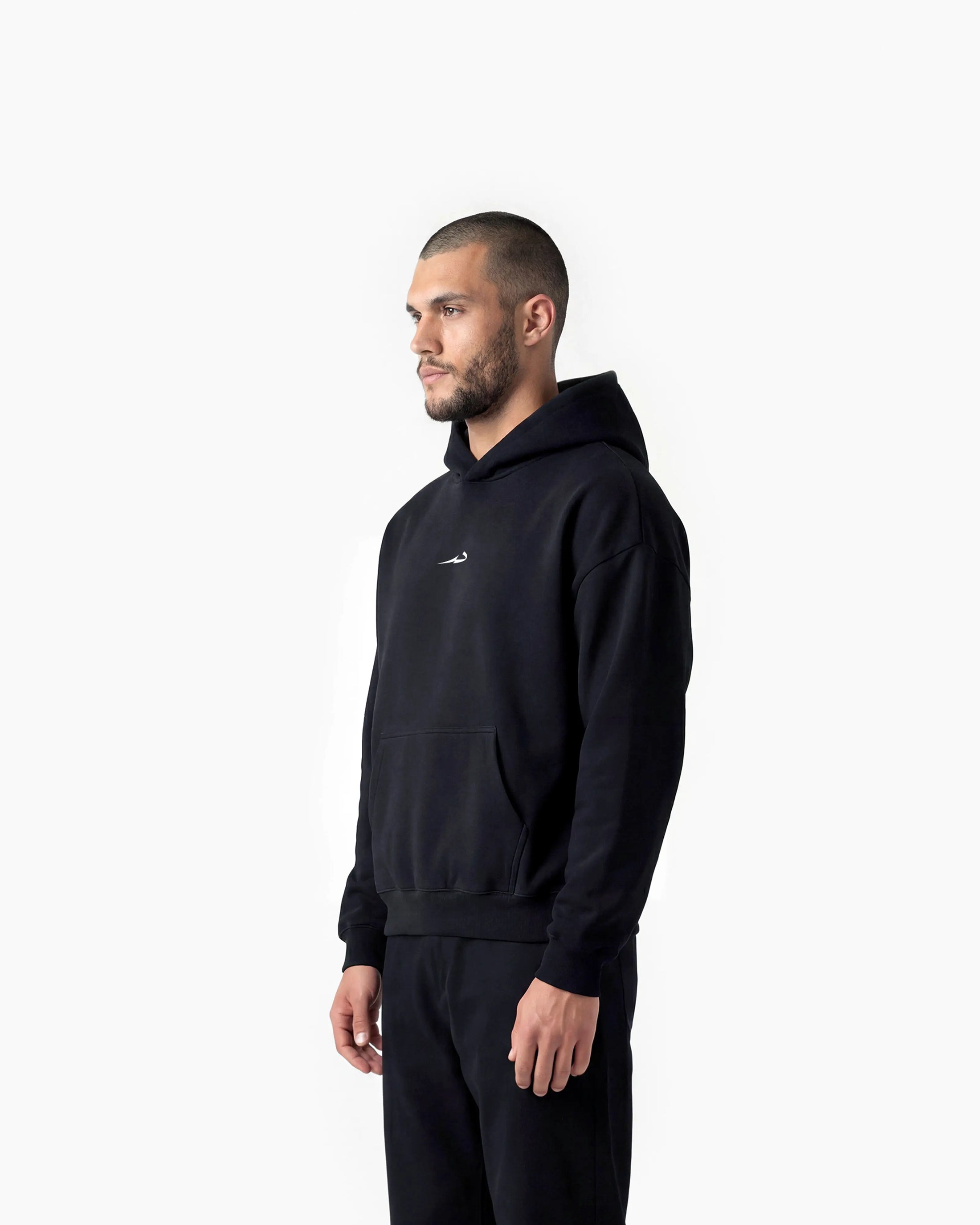 Man wearing a black hoodie with a Deenathletic logo on a white background