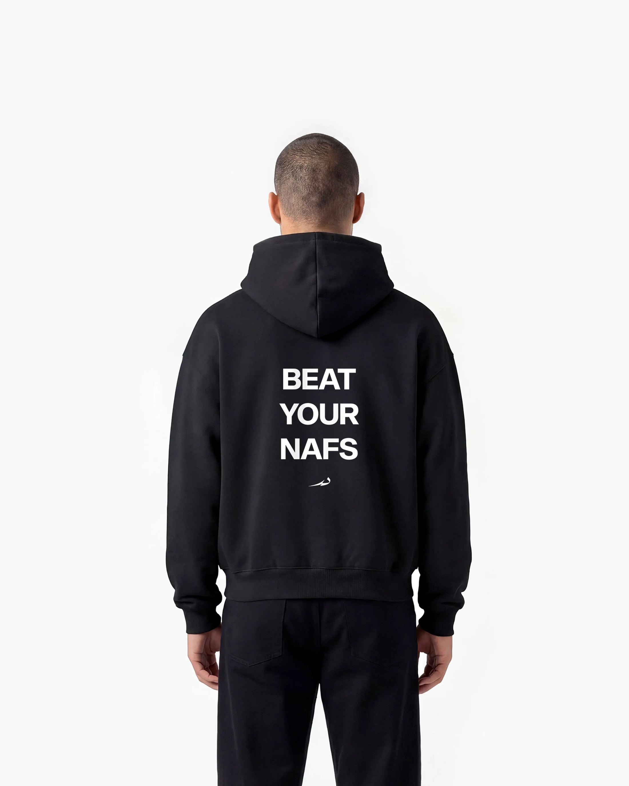 Person wearing a black hoodie with 'BEAT YOUR NAFS' text on the back against a white background