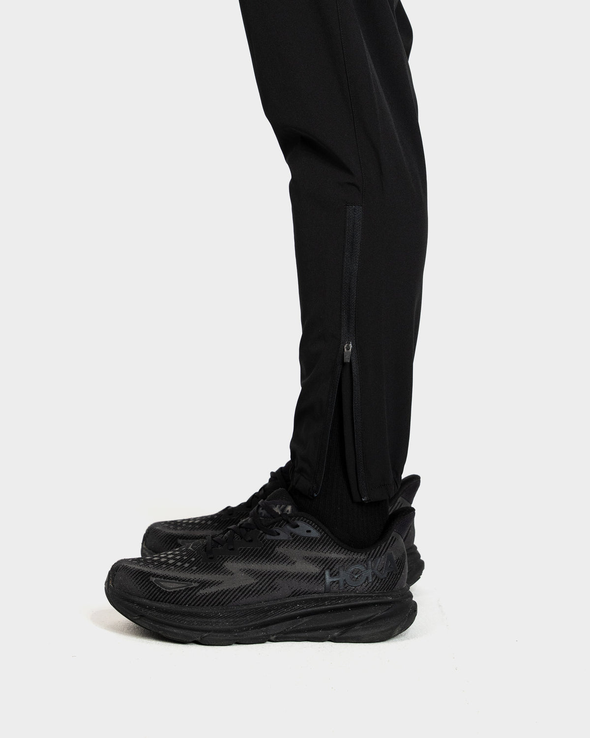 Black athletic shoes with brand logo on a white background