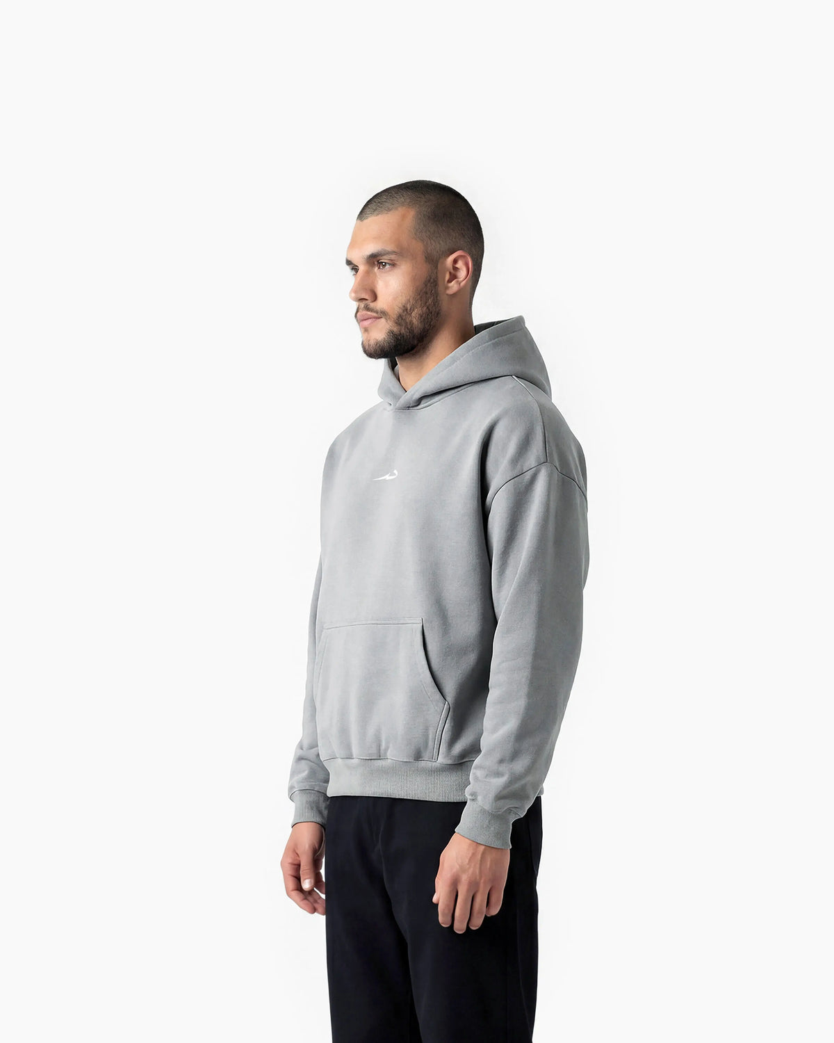 Man wearing a grey Deenathletic hoodie on a white background