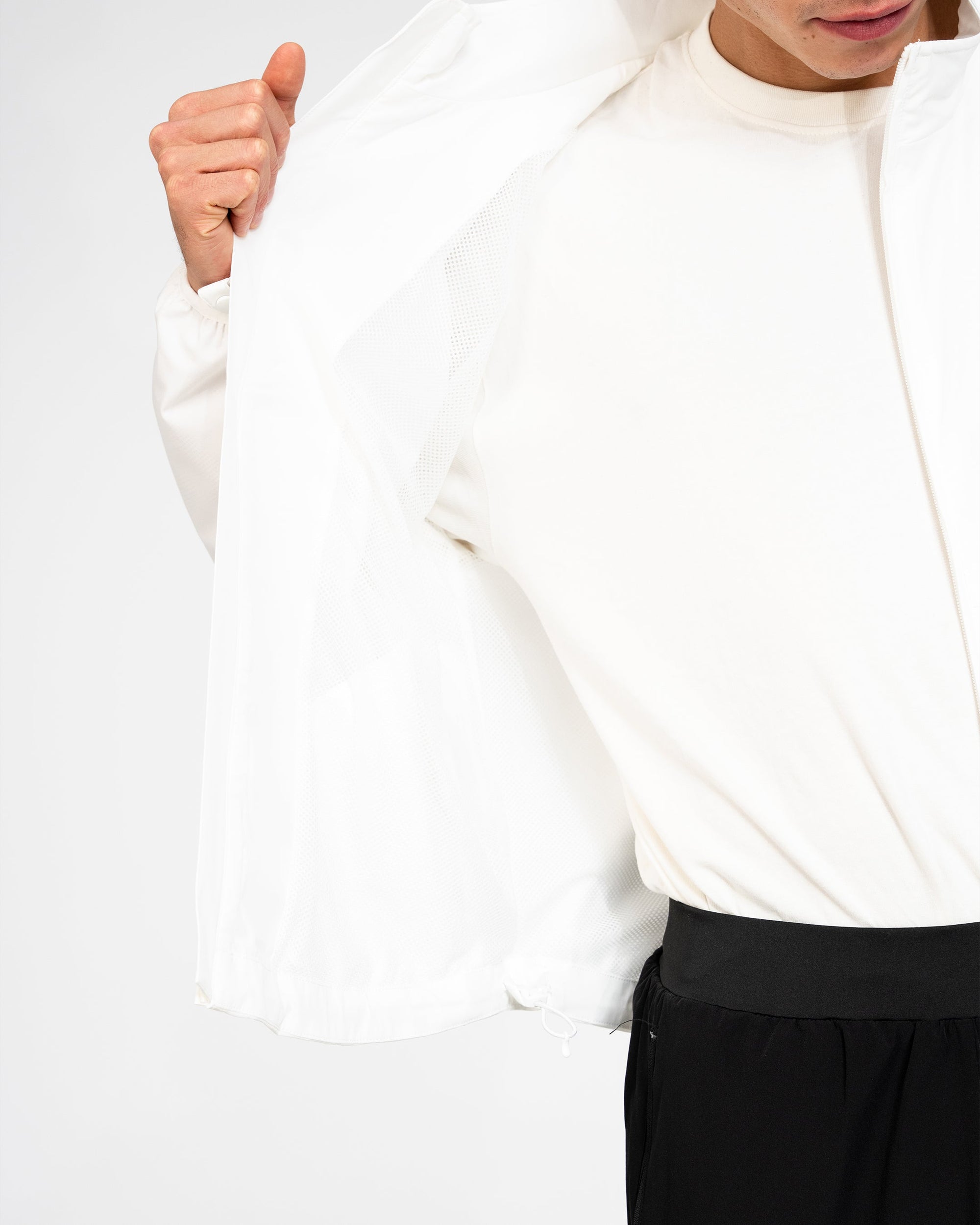 White long-sleeve jacket worn by a person on a white background