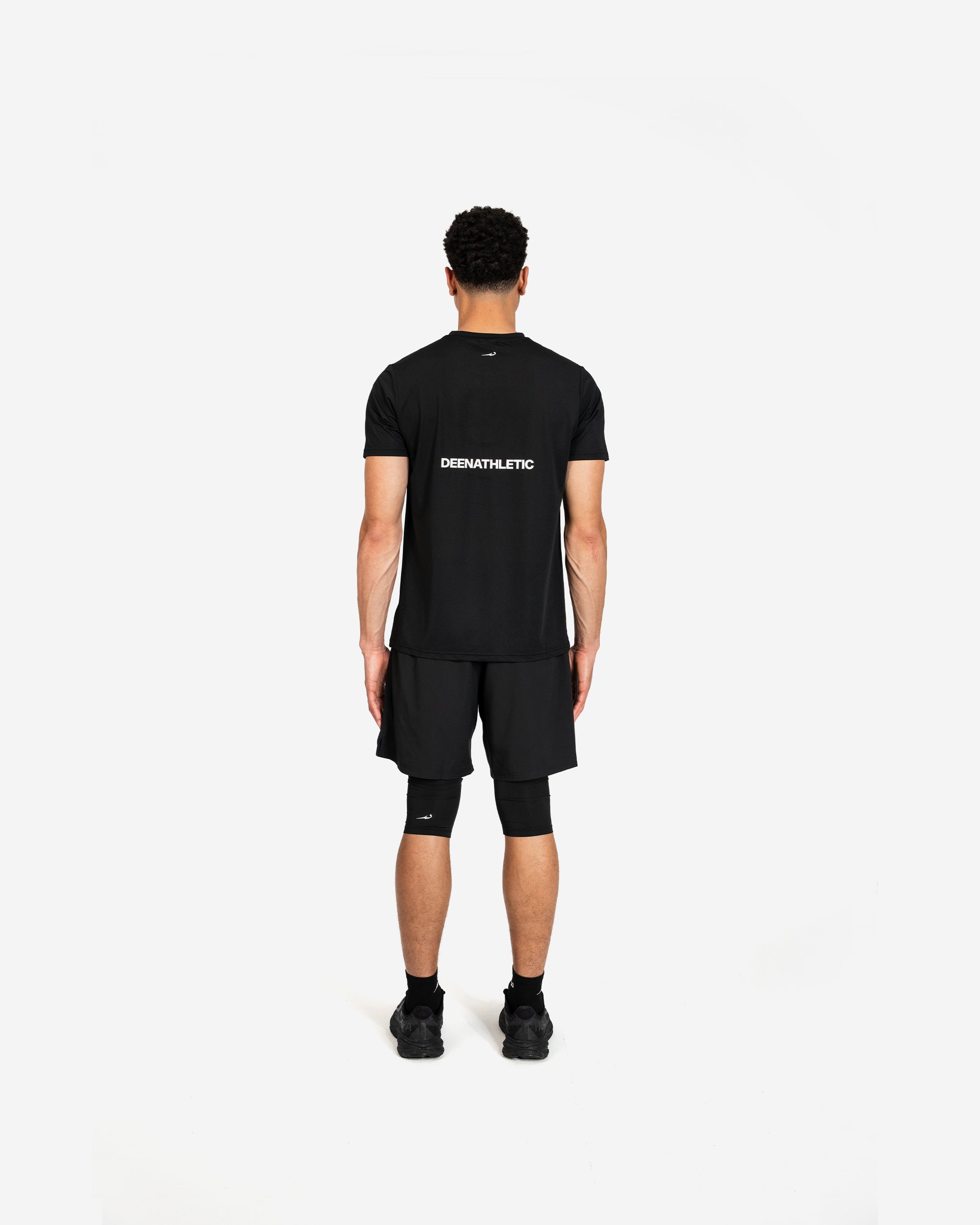 Person wearing a black t-shirt and shorts with 'Deenathletic' branding on a white background
