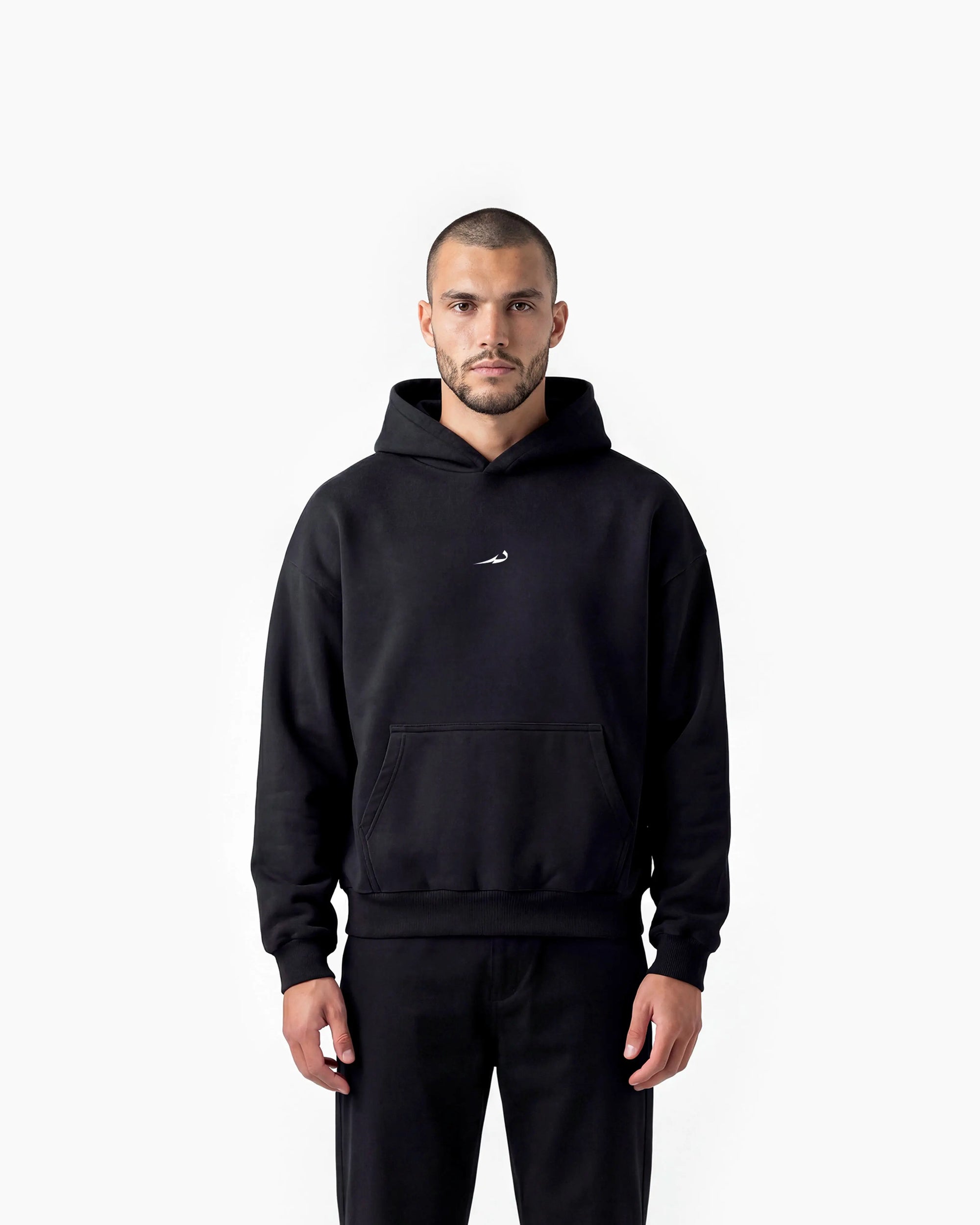 Man wearing a black hoodie with a Deenathletic logo on a white background