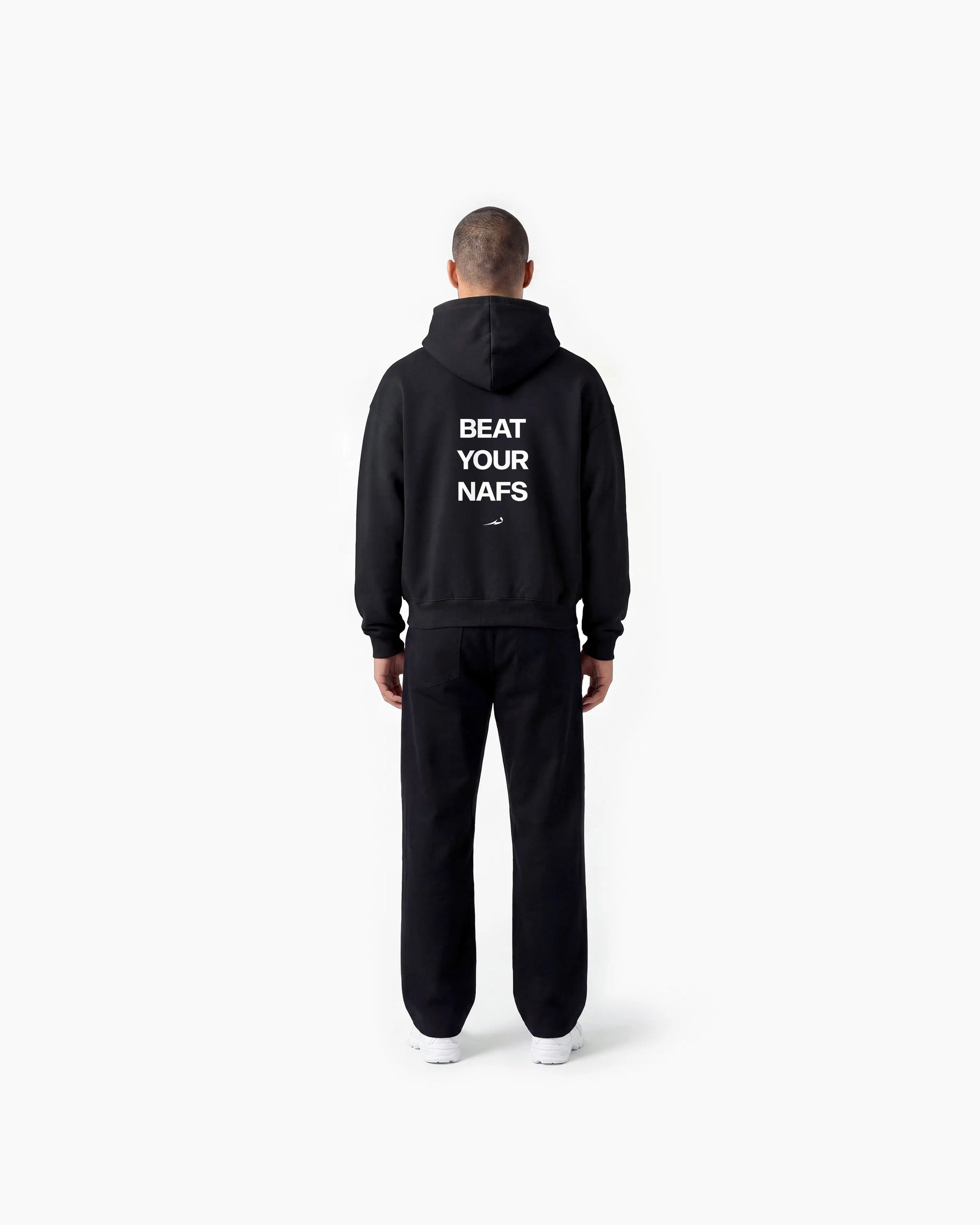 Person wearing a black Deenathletic hoodie with text on the back, standing against a white background