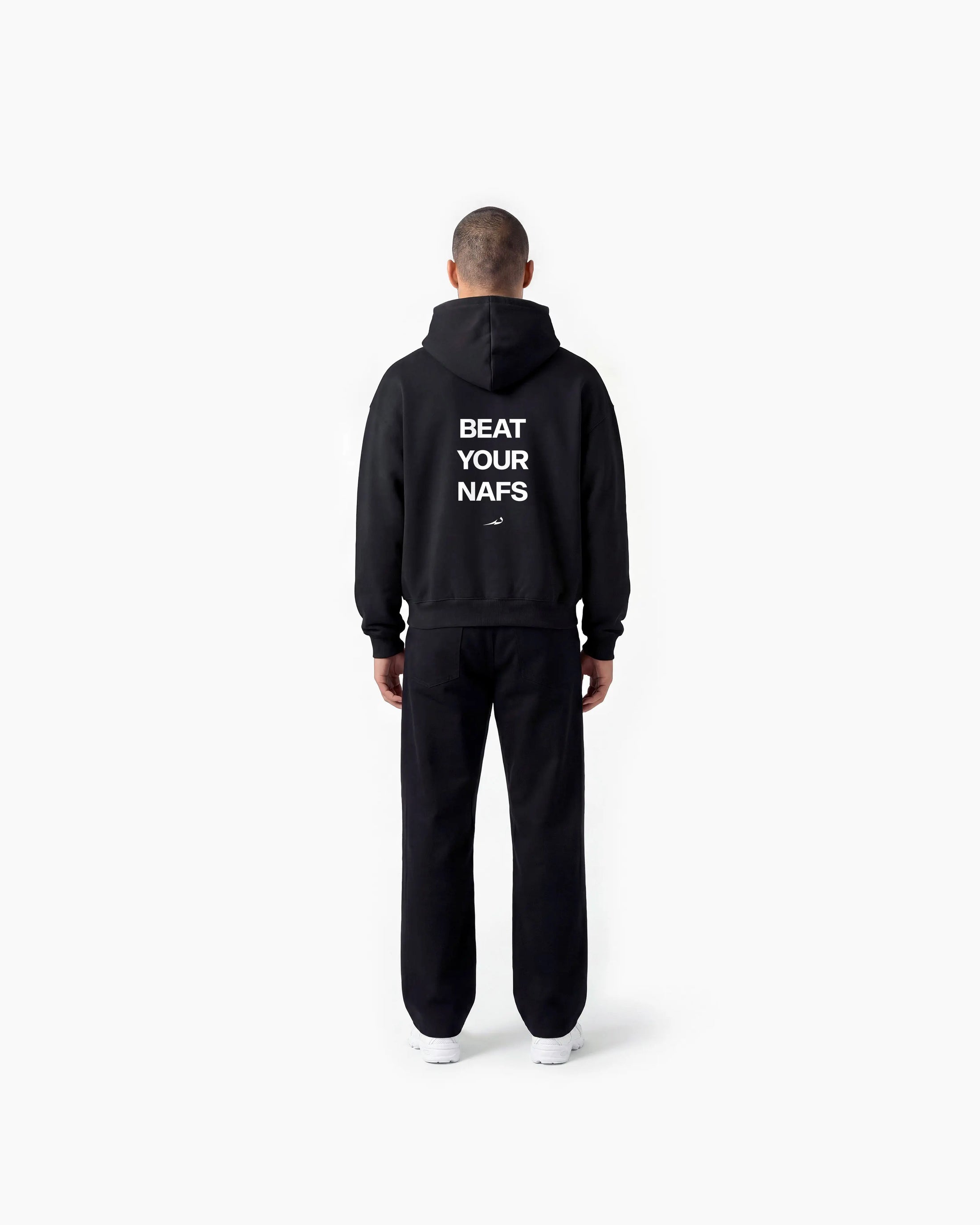 Person wearing a black Deenathletic hoodie with text on the back, standing against a white background