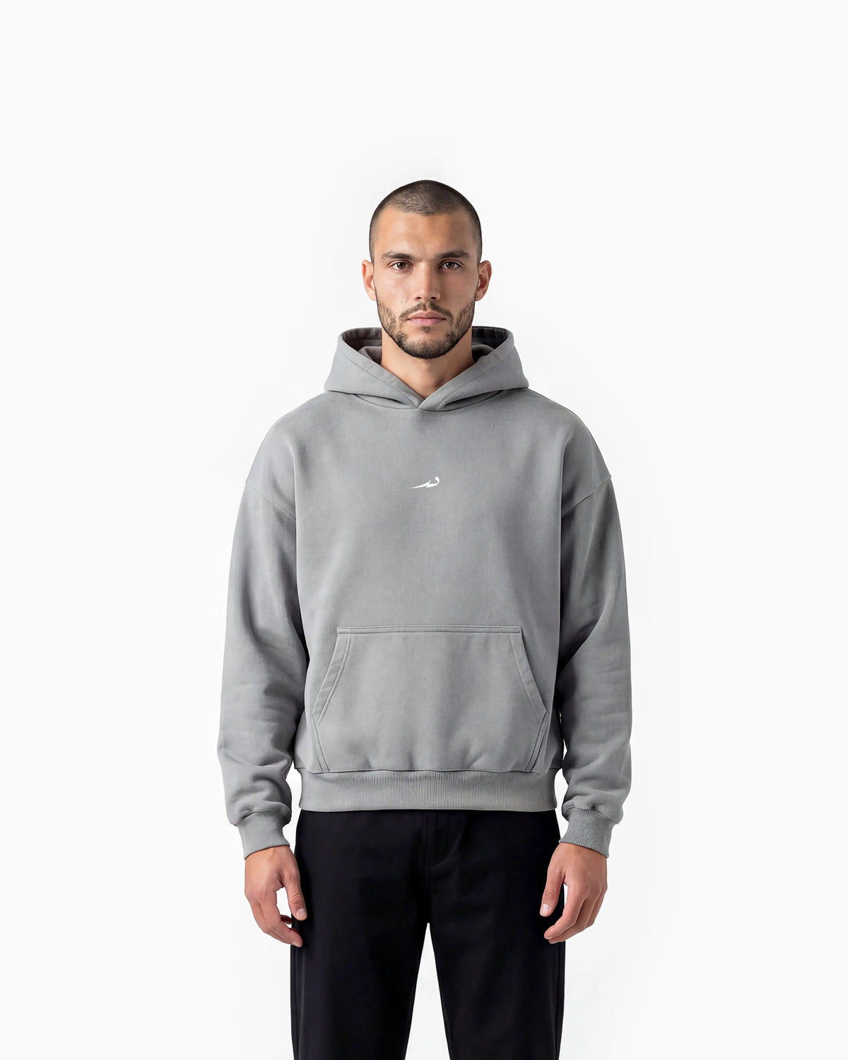 Man wearing a grey Deenathletic hoodie with a small logo on a white background