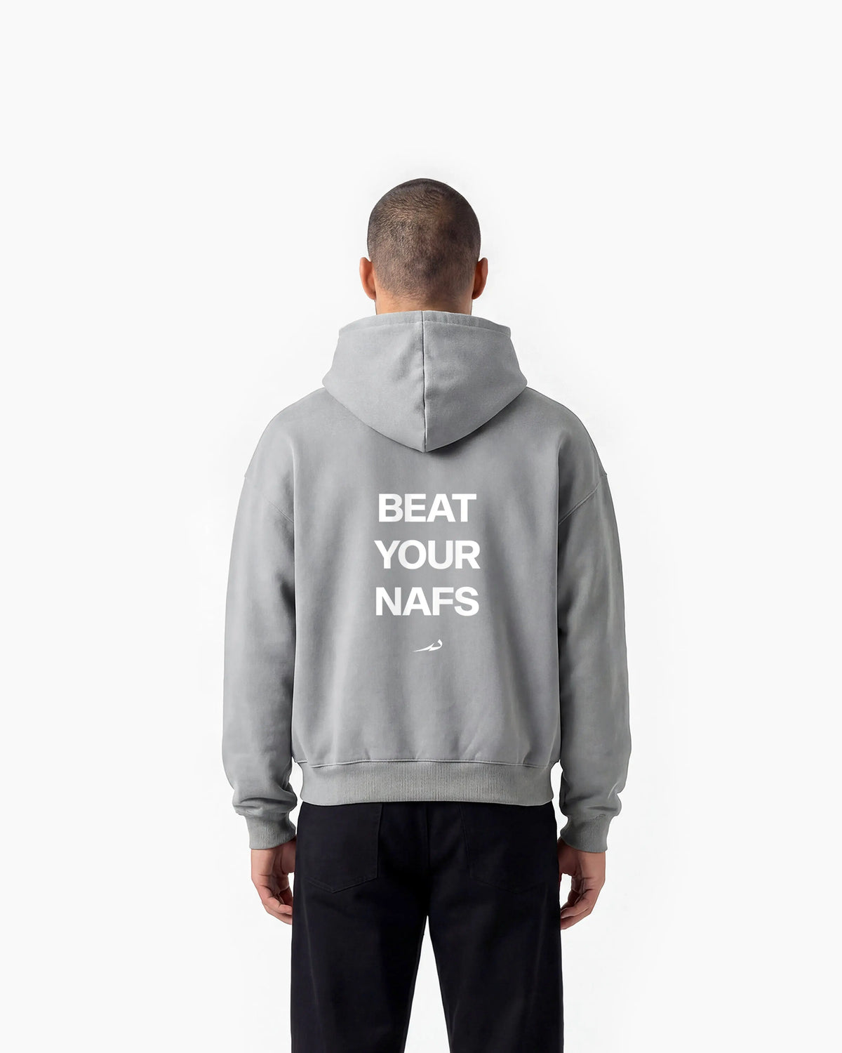 Person wearing a grey hoodie with 'Beat Your Nafs' text on the back, standing against a white background