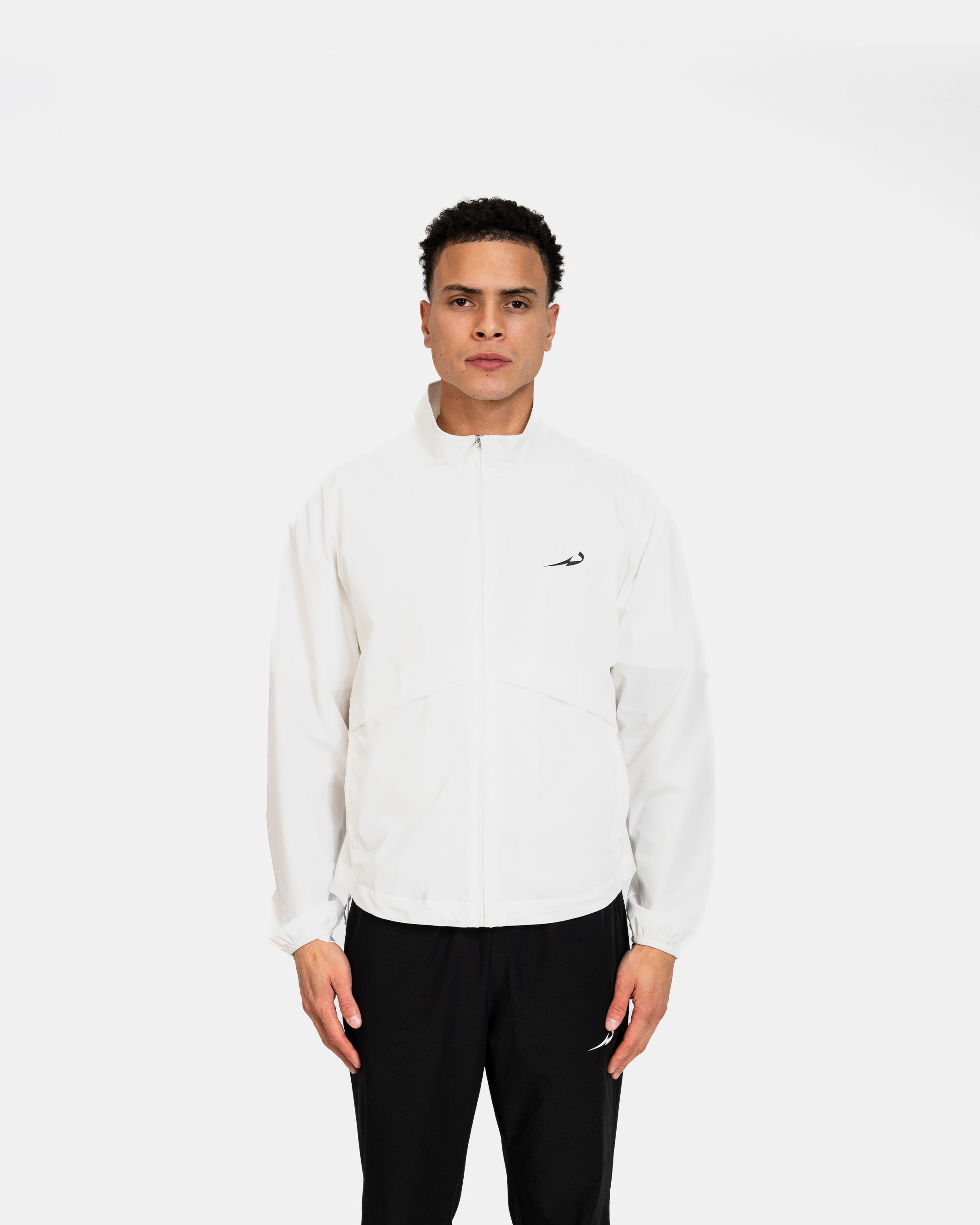 Person wearing a white jacket with a logo on a white background